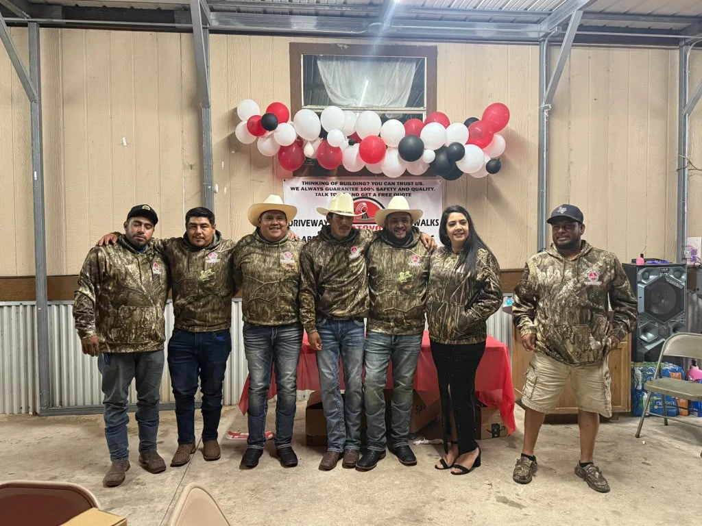 The Santoyo's Concrete Work crew in branded jackets at a company event